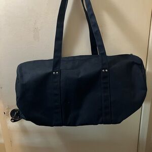 Black Duffel Bag with Textured Fabric and Elongated Shape